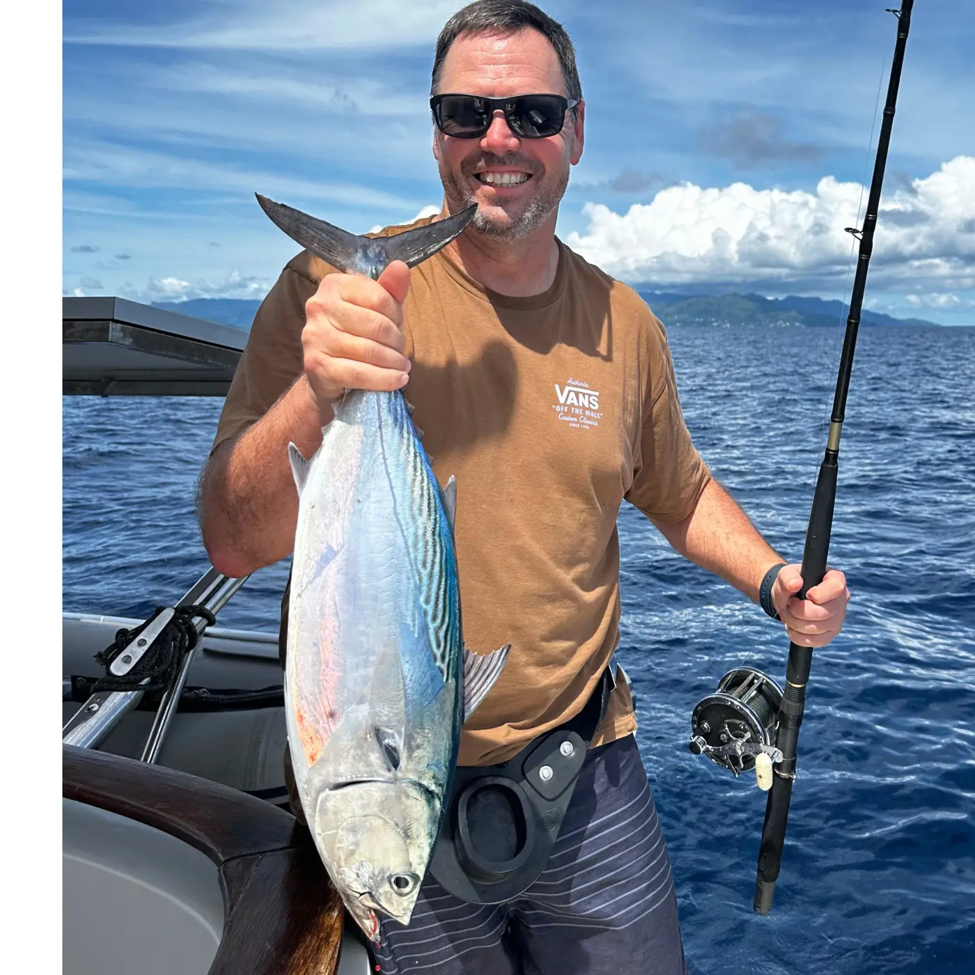 Angler holding a dogtooth tuna caught jigging in the Seychelles