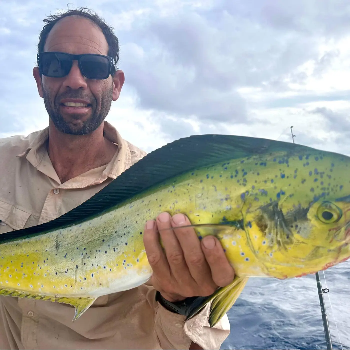 Angler holding a dorado caught offshore in the Seychelles