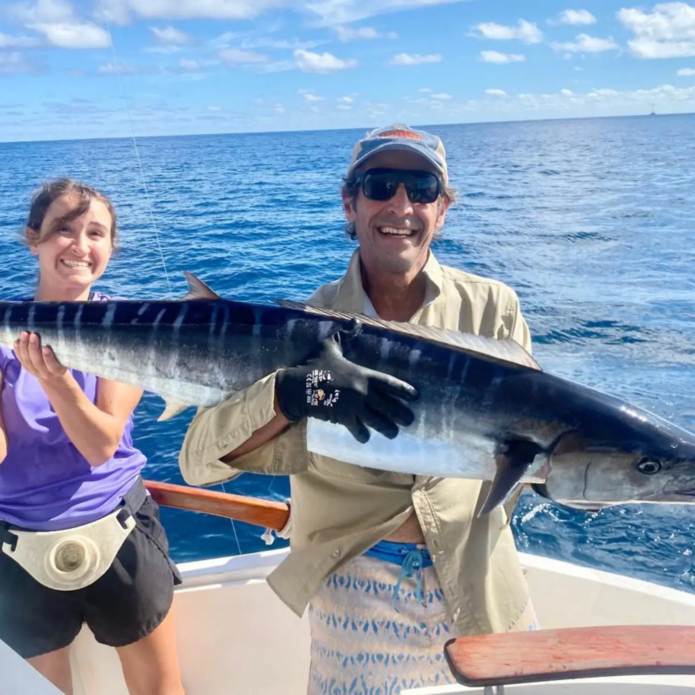 Anglers holding a wahoo caught trolling in the Seychelles