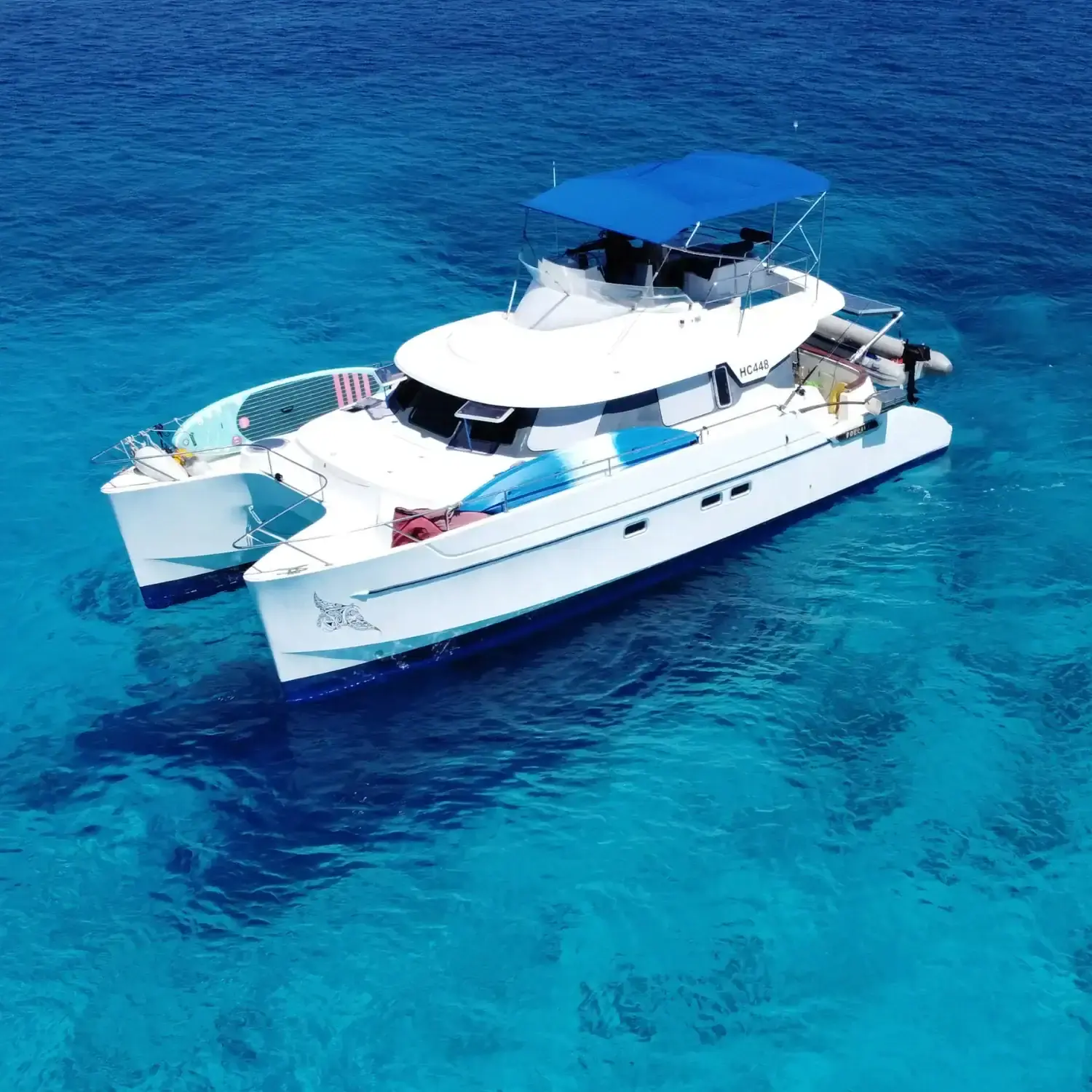 Poerava, a Fountaine Pajot Maryland 37 power catamaran, at anchor over turquoise water in the Seychelles